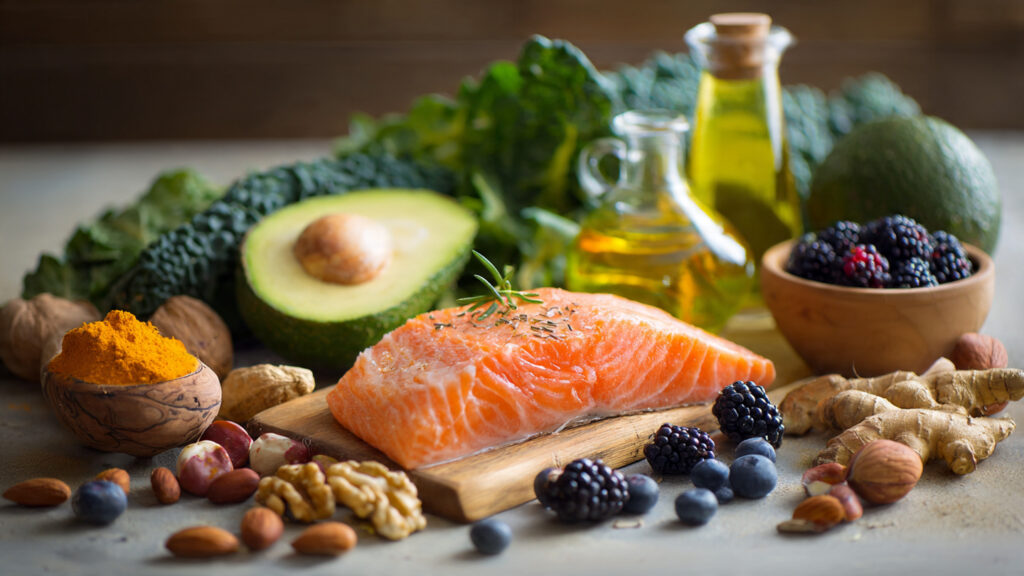 Anti-inflammatory foods including salmon, berries, leafy greens, olive oil, and turmeric that help reduce inflammation and joint pain.