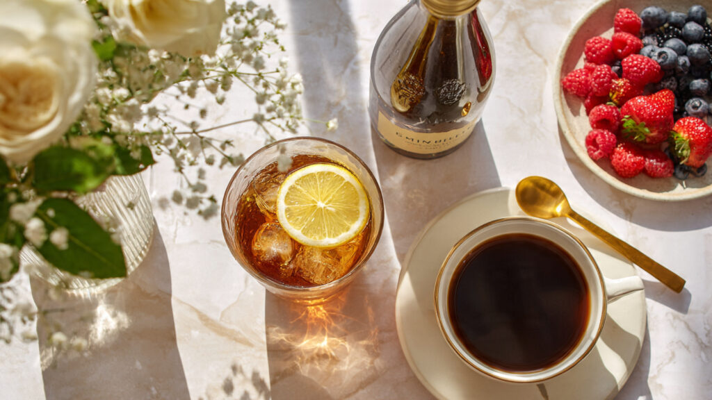 A variety of safe drinks for diabetics including black coffee, herbal tea, and sparkling water on a clean wooden table.